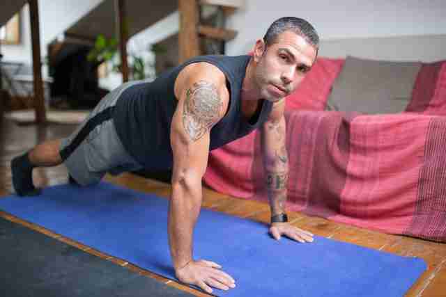 man doing push ups on a yoga mat showing self-care for men