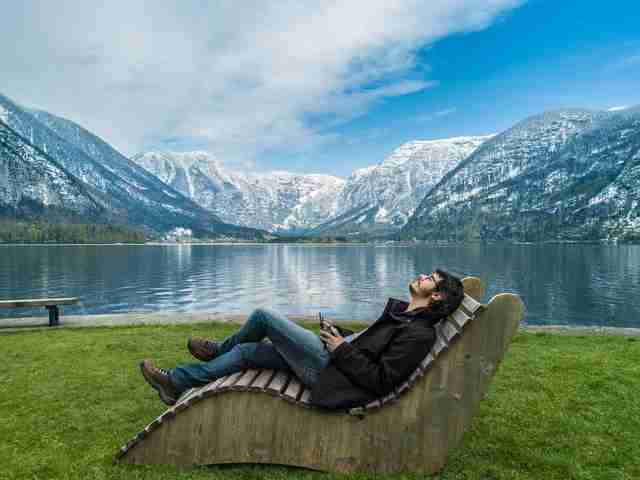 man lying on a lounger in nature showing how to make wellness part of your daily routine