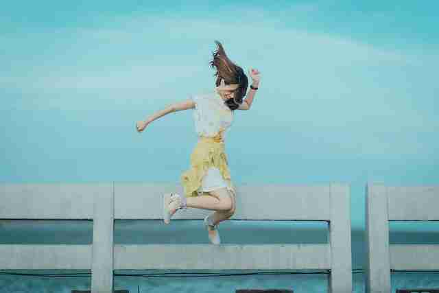 woman jumping for joy in air