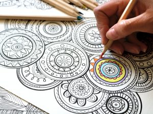 person coloring for self-care as art