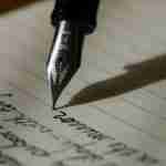 pen writing on lined paper for journaling course self-coaching resources