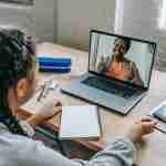 woman watching virtual courses as self-coaching tools