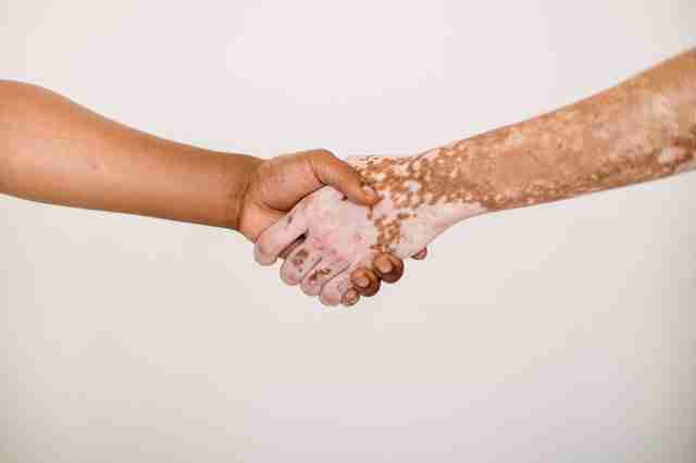 Two people shaking hands to show mutual respect