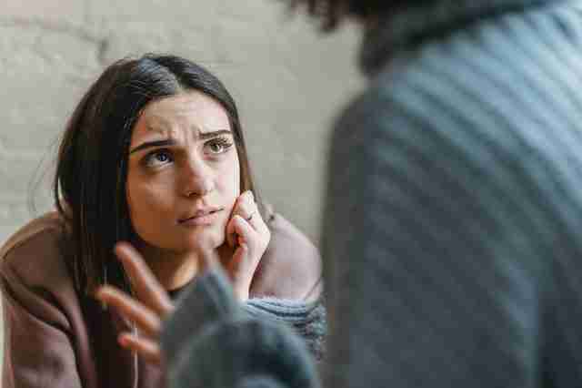 woman listening patiently to a difficult person tell them something